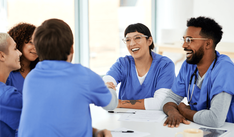 Shot of a young doctor shaking hands with her colleague during a meeting in a hospital