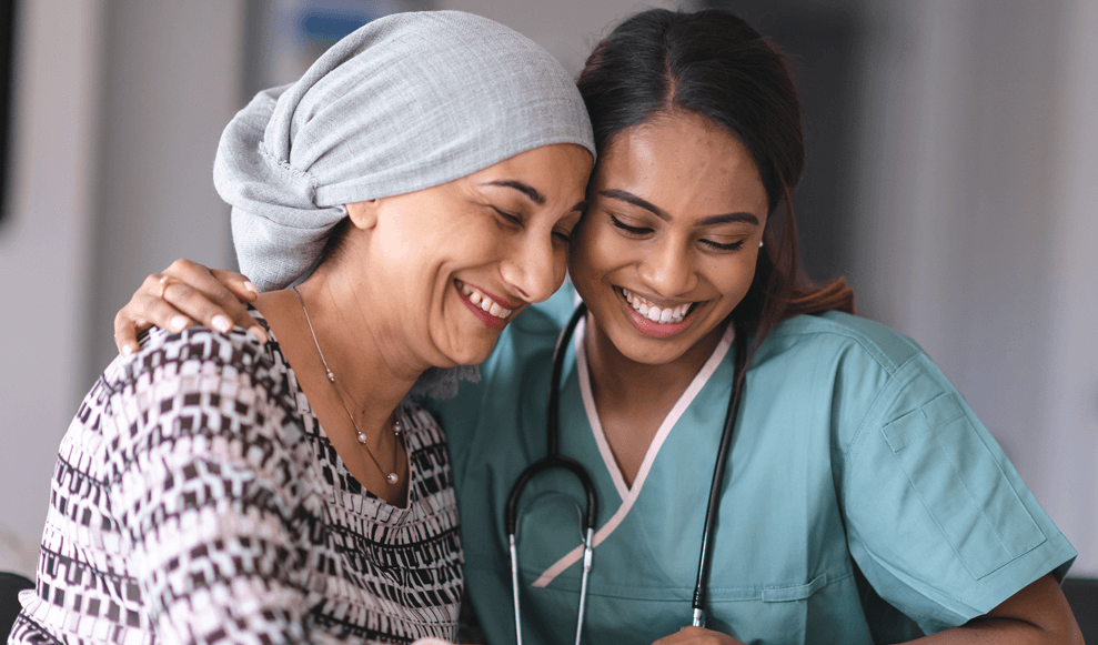 A Nurse and a patient smiling together looking at results