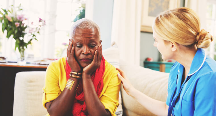 Community Nurse Visits Senior Woman Suffering With Depression