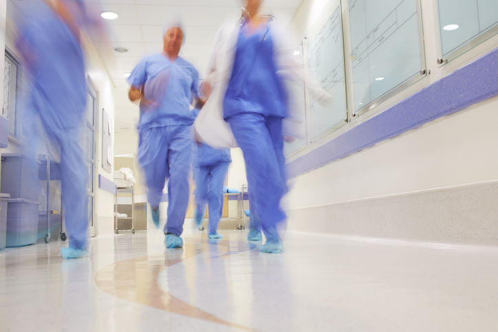 Blurred image of medical staff running through the hospital corridors