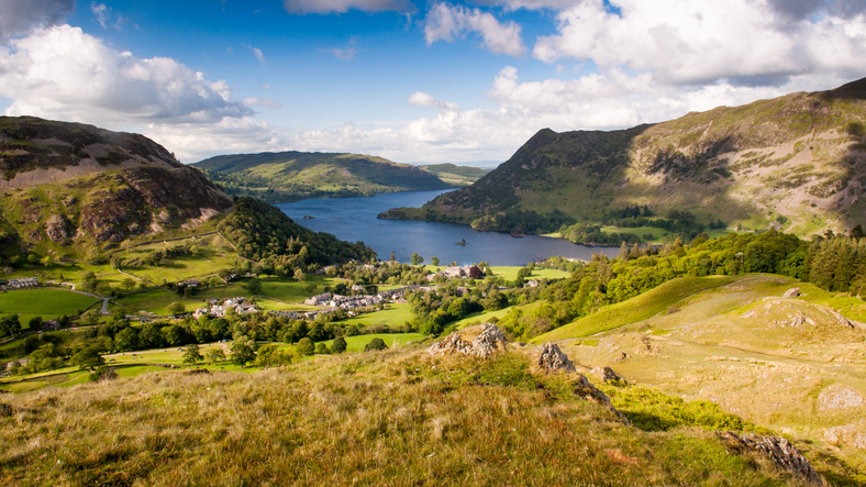 Ullswater lake curves through the mountains of the English Lake District at Glenridding, looking down on the lake from the crags of Birkhouse Moor.