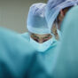 masked healthcare professional in surgery