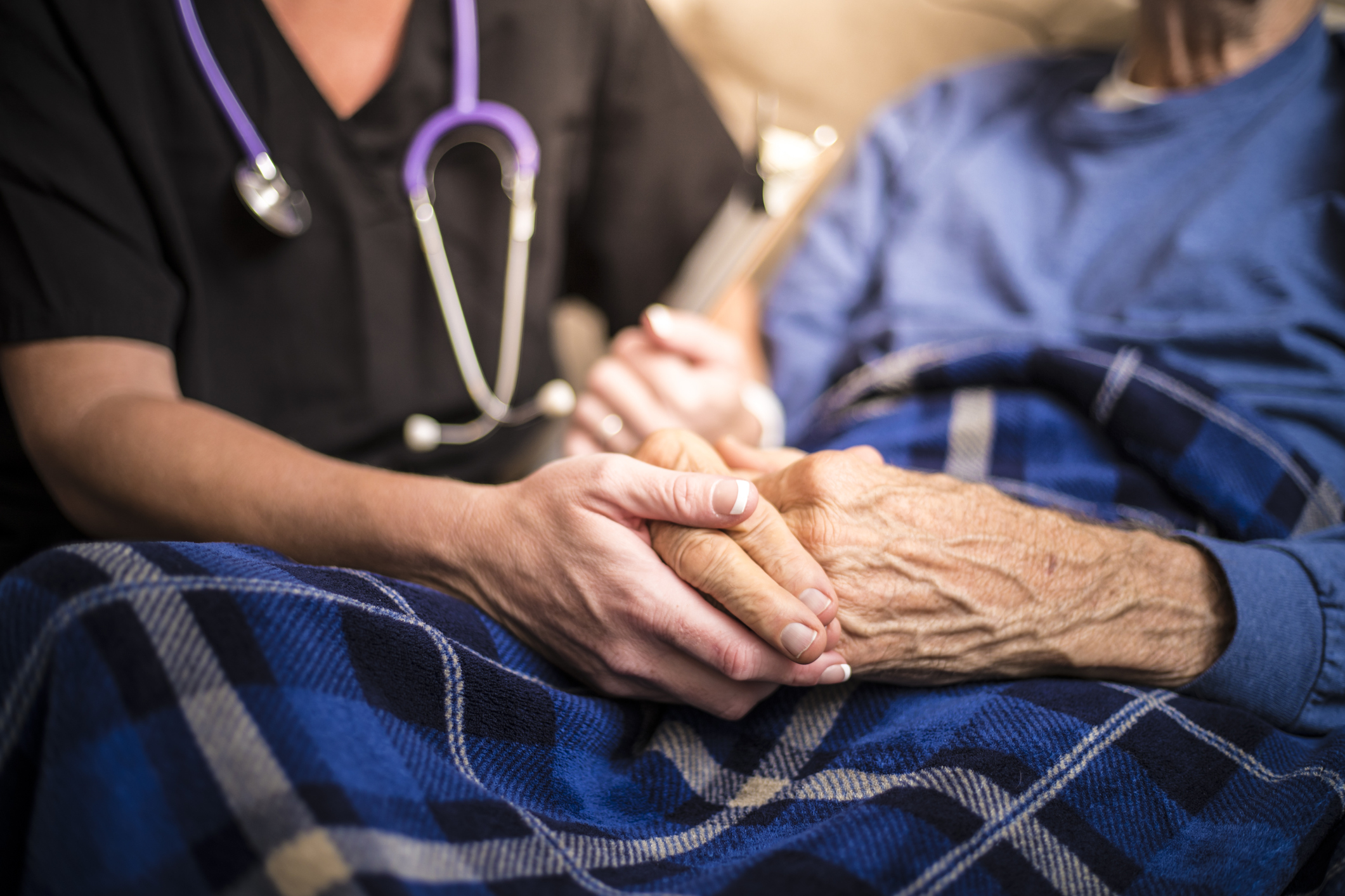 A Nurse visiting an Elderly male patient who is receiving hospice/palliative care