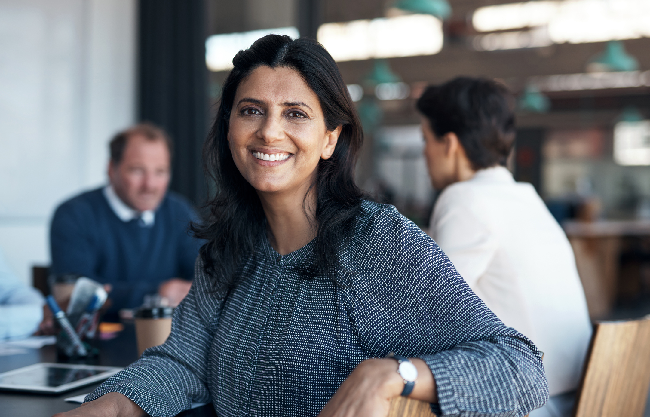 Portrait of a businesswoman having a meeting with her team in a modern office