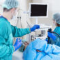 scene displaying healthcare professionals working on a patient and looking at screen