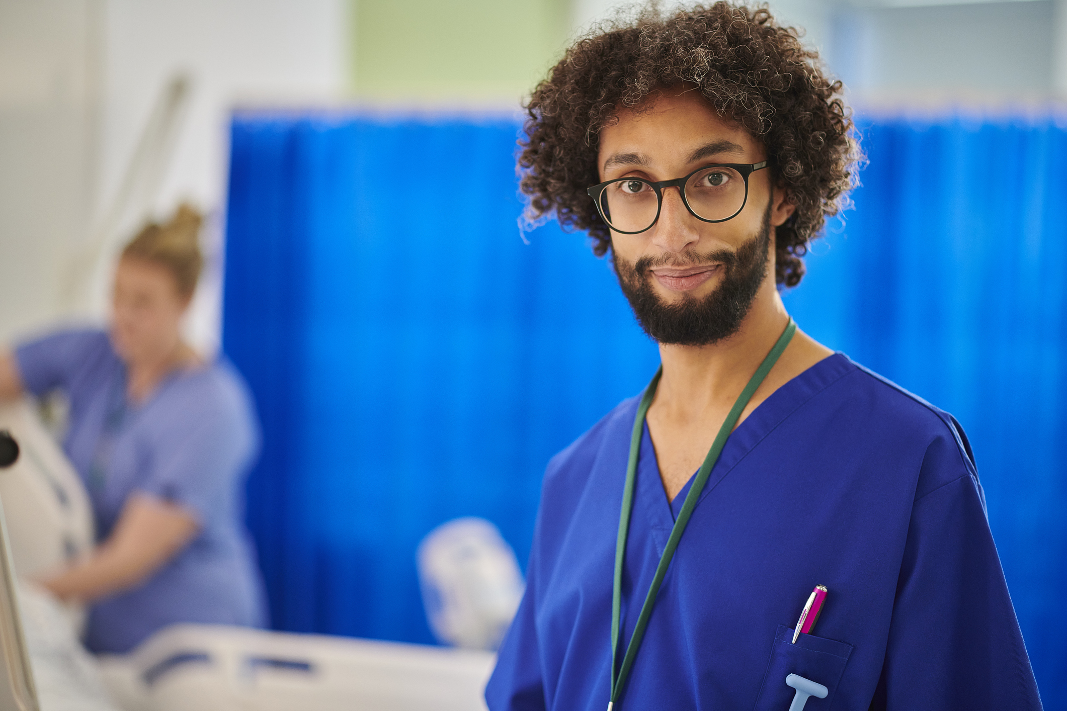 Portrait of a male Nurse wearing glasses on a hospital ward