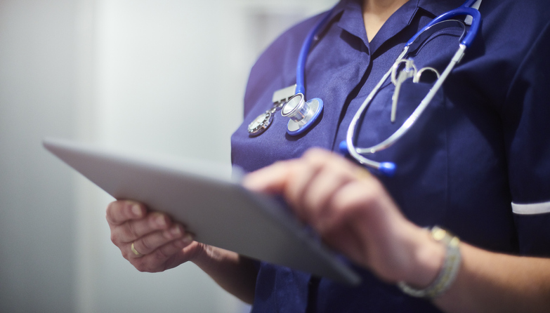 Female Nurse using a digital tablet to check data