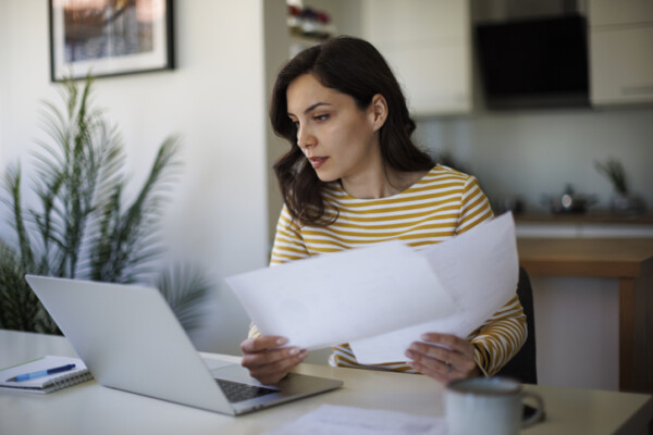Young woman going throught her finances at home