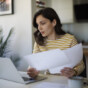 Young woman going throught her finances at home