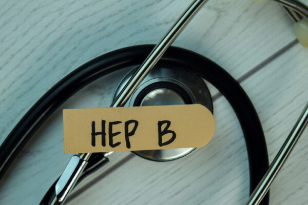 Hep B write on sticky notes isolated on Wooden Table. healthcare Concept