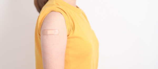 Adult Woman with bandage after received vaccine. Vaccination and Immunization for Influenza, HPV, Zoster, IPD, DTP or Diphtheria, Tetanus and Pertussis, MMR, Hepatitis B, Covid and Varicella vaccine